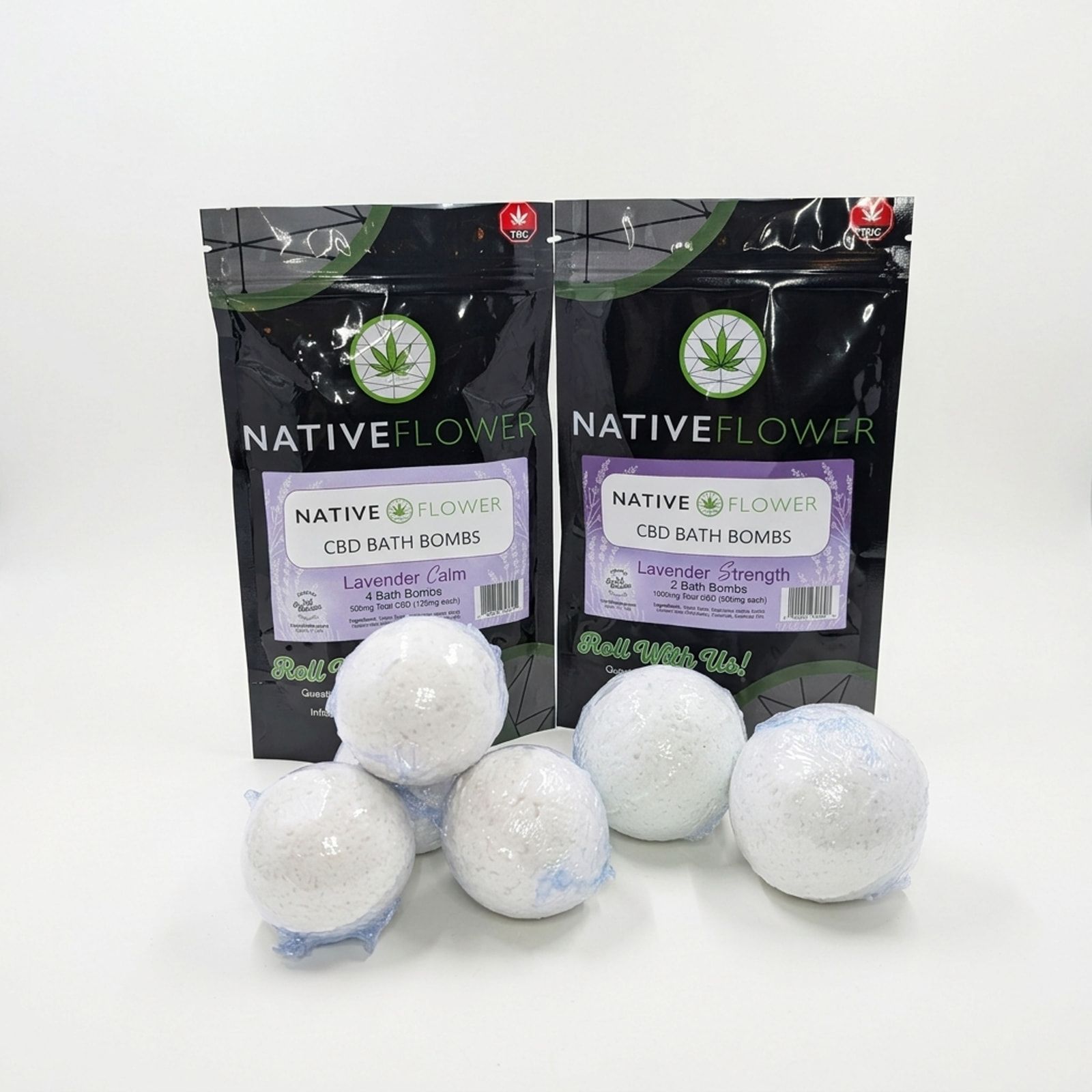 Two Native Flower CBD bath bomb pouches with lilac labels behind six white bath bombs in clear wrap, on a white background.