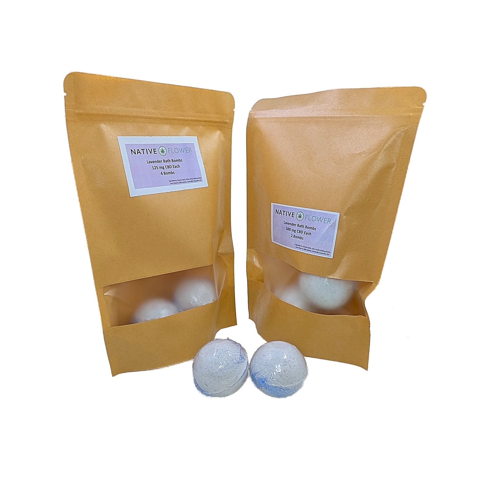 Two kraft Native Flower pouches of lavender bath bombs, each with a window showing the bombs inside, and two pale blue bath bombs in front.