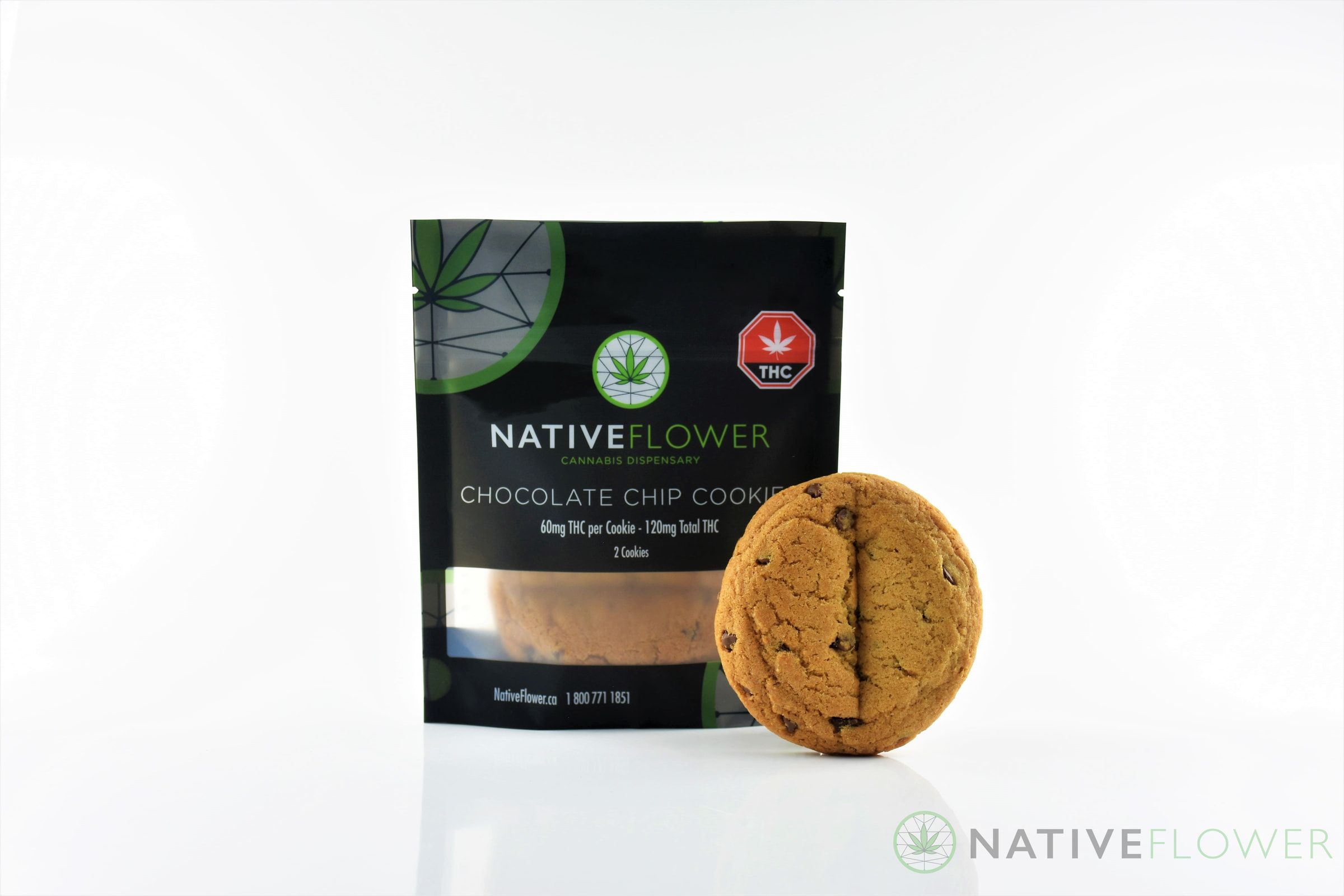 A Native Flower chocolate chip cookie leaning against its black pouch.