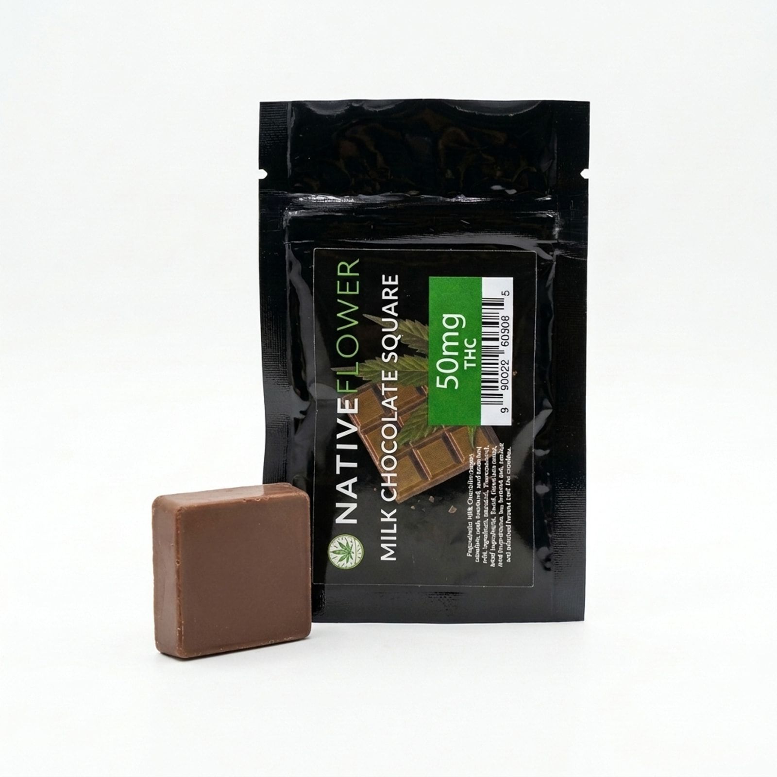 A milk chocolate square propped against its black Native Flower pouch on a white background.