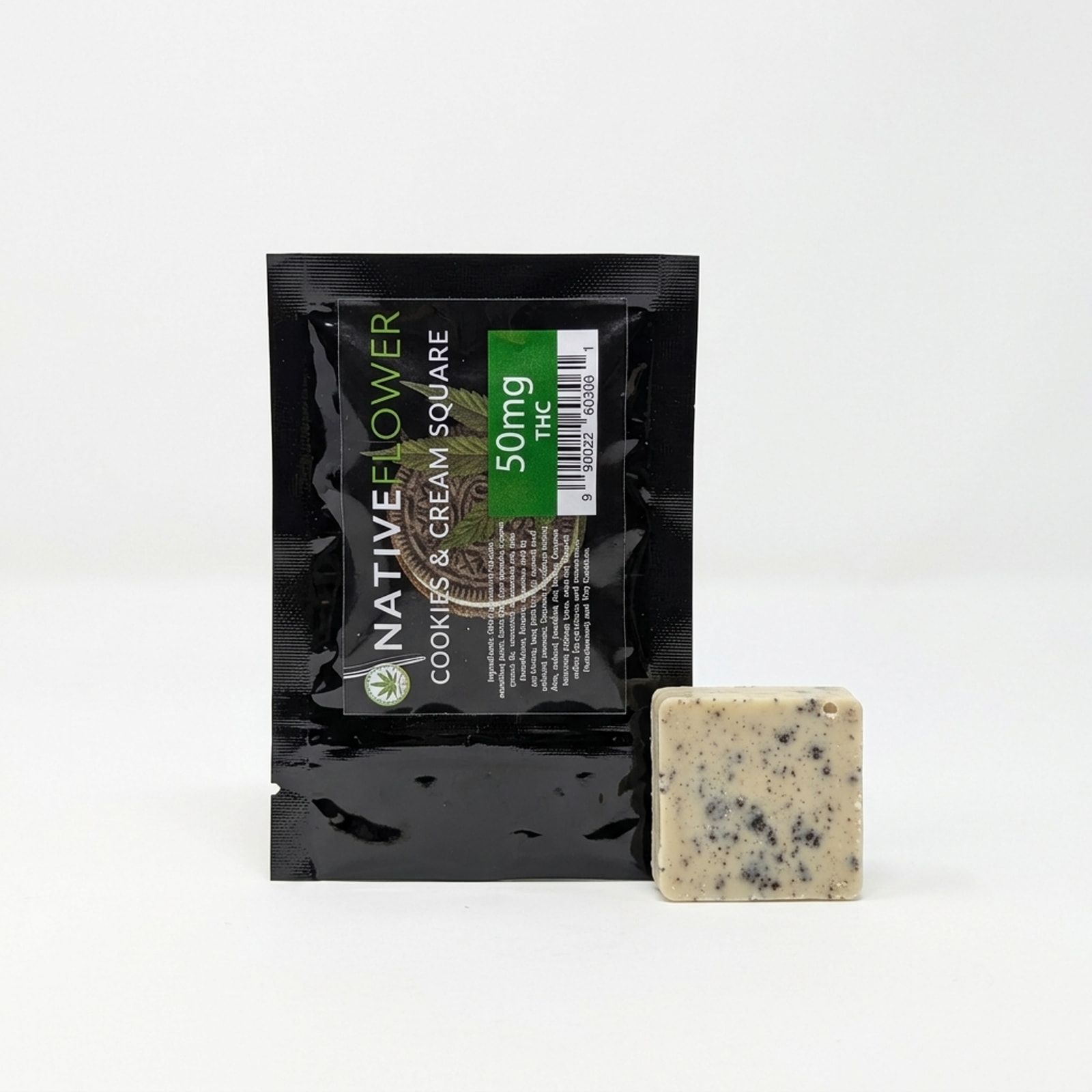 A cookies-and-cream square leaning against its black Native Flower pouch on a white background.