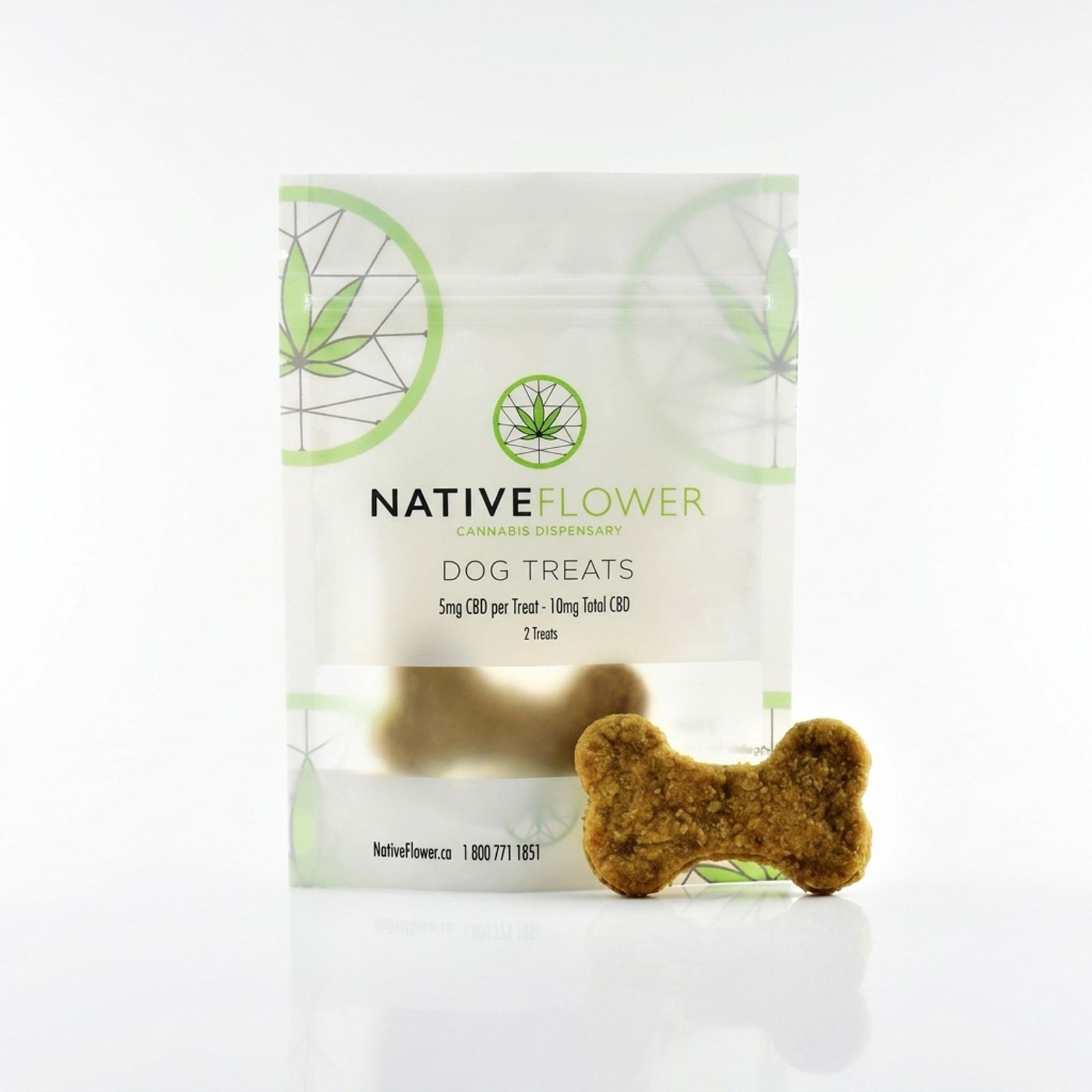 A bone-shaped dog biscuit leaning against its white Native Flower dog treats pouch on a white background.