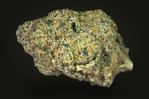 A cured bud of Firewalker OG, olive green and tan with short orange hairs under a granular frost, on a plain black background.