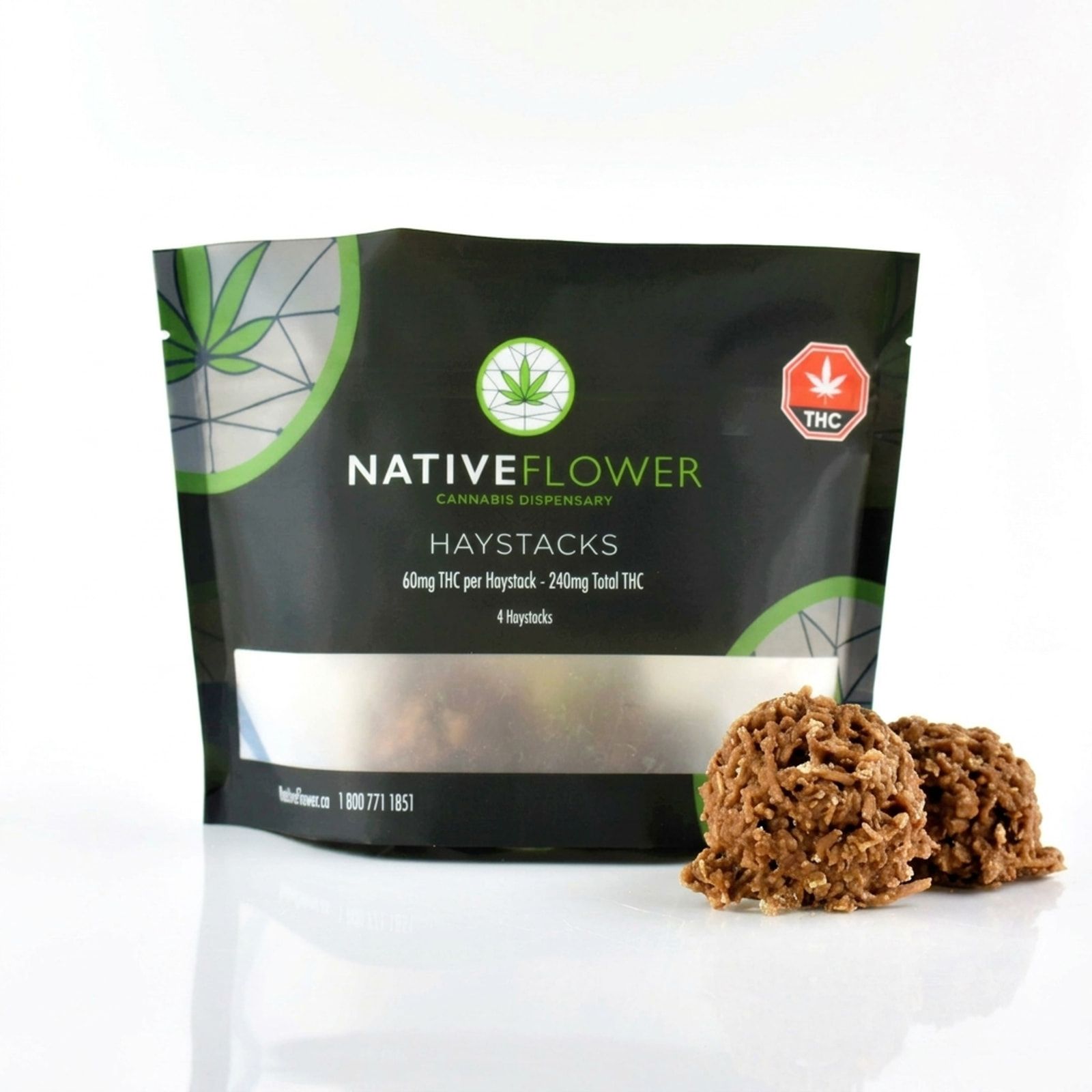 Two chocolate coconut haystacks beside their black Native Flower pouch on a white background.