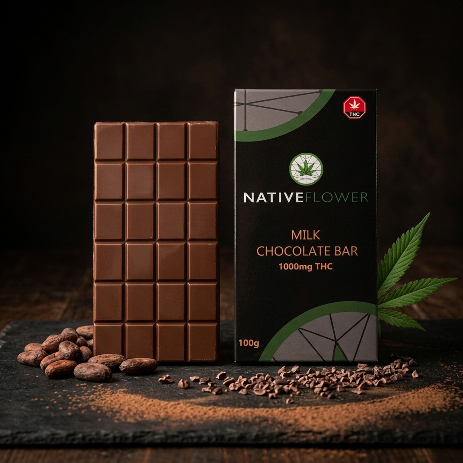 An unwrapped milk chocolate bar standing beside its black Native Flower box on slate, with cocoa beans, cacao nibs and a cannabis leaf.