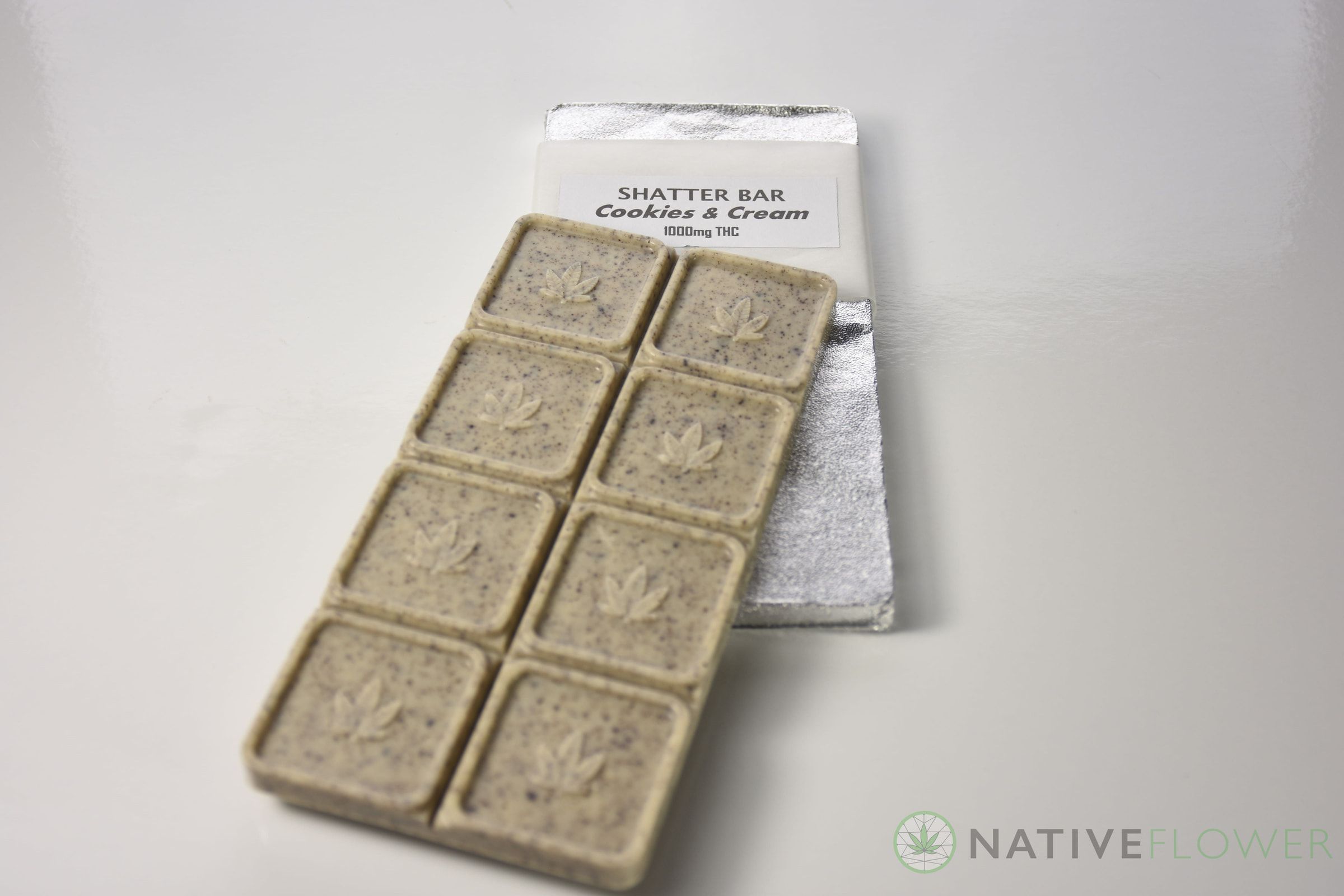 A segmented cookies-and-cream bar resting on its opened foil wrapper.