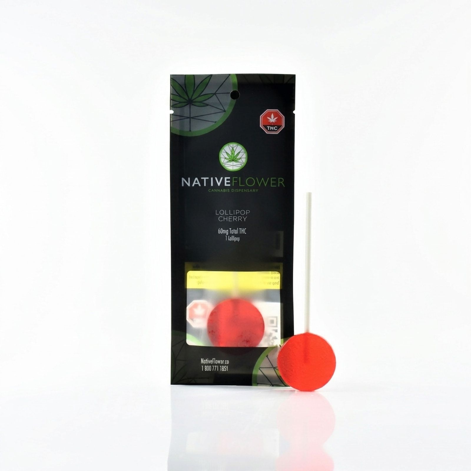 A Native Flower cherry lollipop pouch standing upright, an unwrapped red lollipop leaning against it, on a white background.
