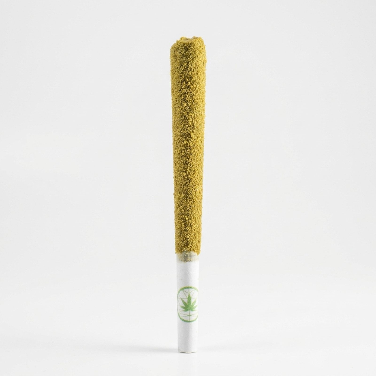 A single kief-coated lunar spliff standing upright, the Native Flower logo printed in green on its white filter, on a white background.