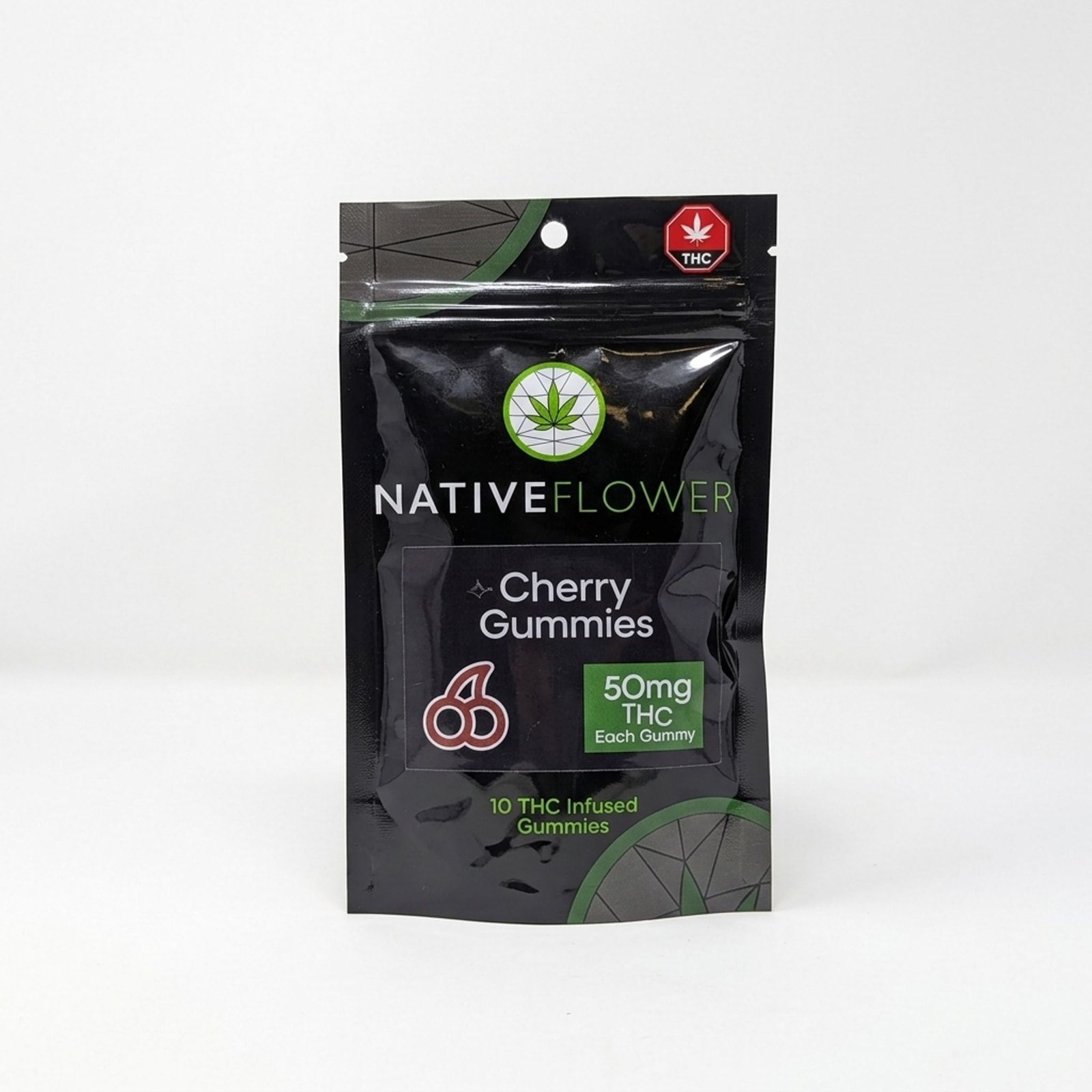 A black Native Flower cherry gummies pouch with a green label panel, standing upright on a white background.