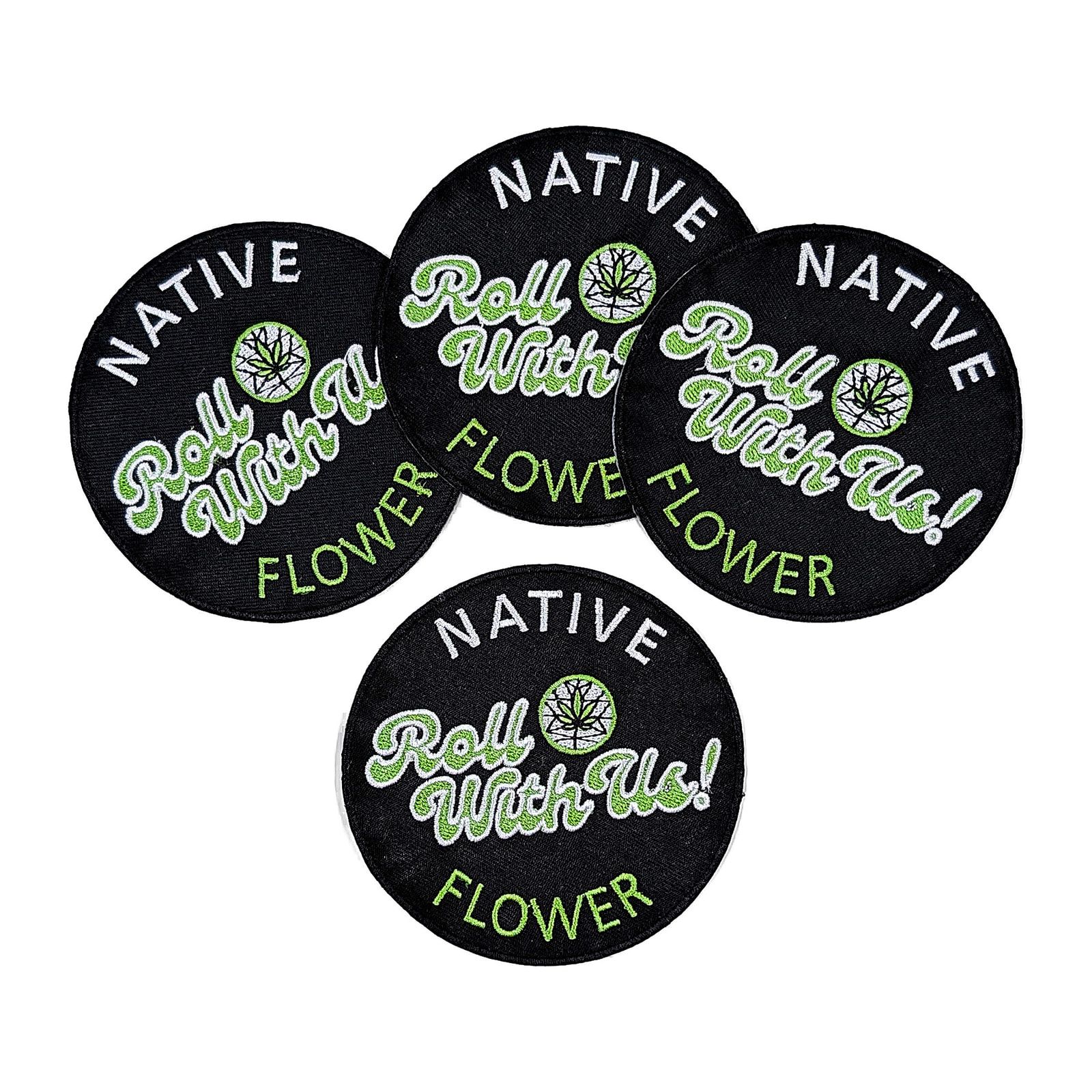 Four round black Native Flower iron-on patches overlapping, each embroidered with Roll With Us in green and white.