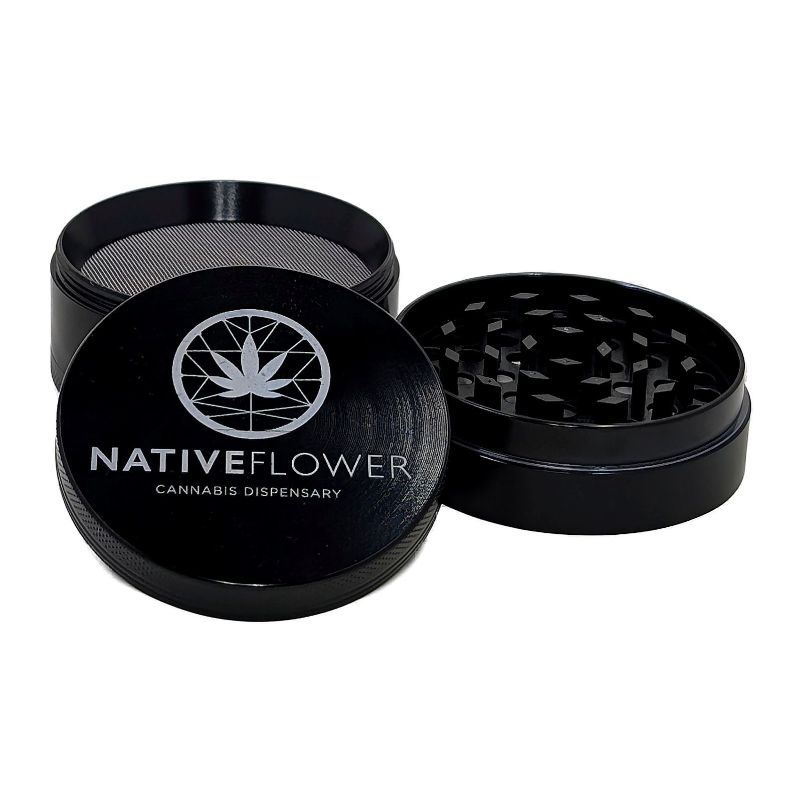 The black grinder open in two halves, showing the kief screen in the base and the teeth in the lid.