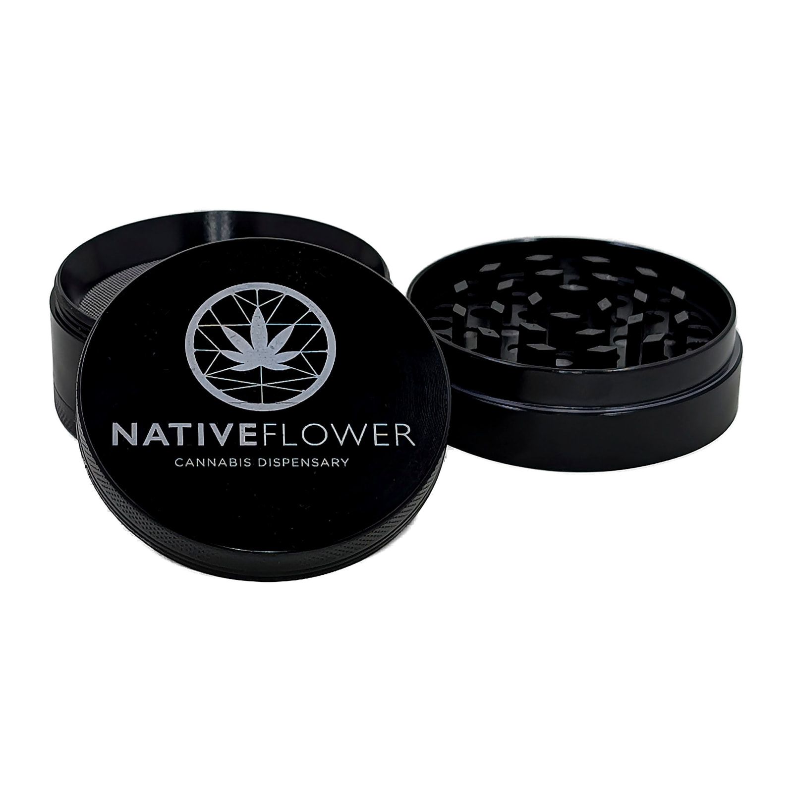 The black grinder from above, lid resting against the body, the etched logo catching the light.