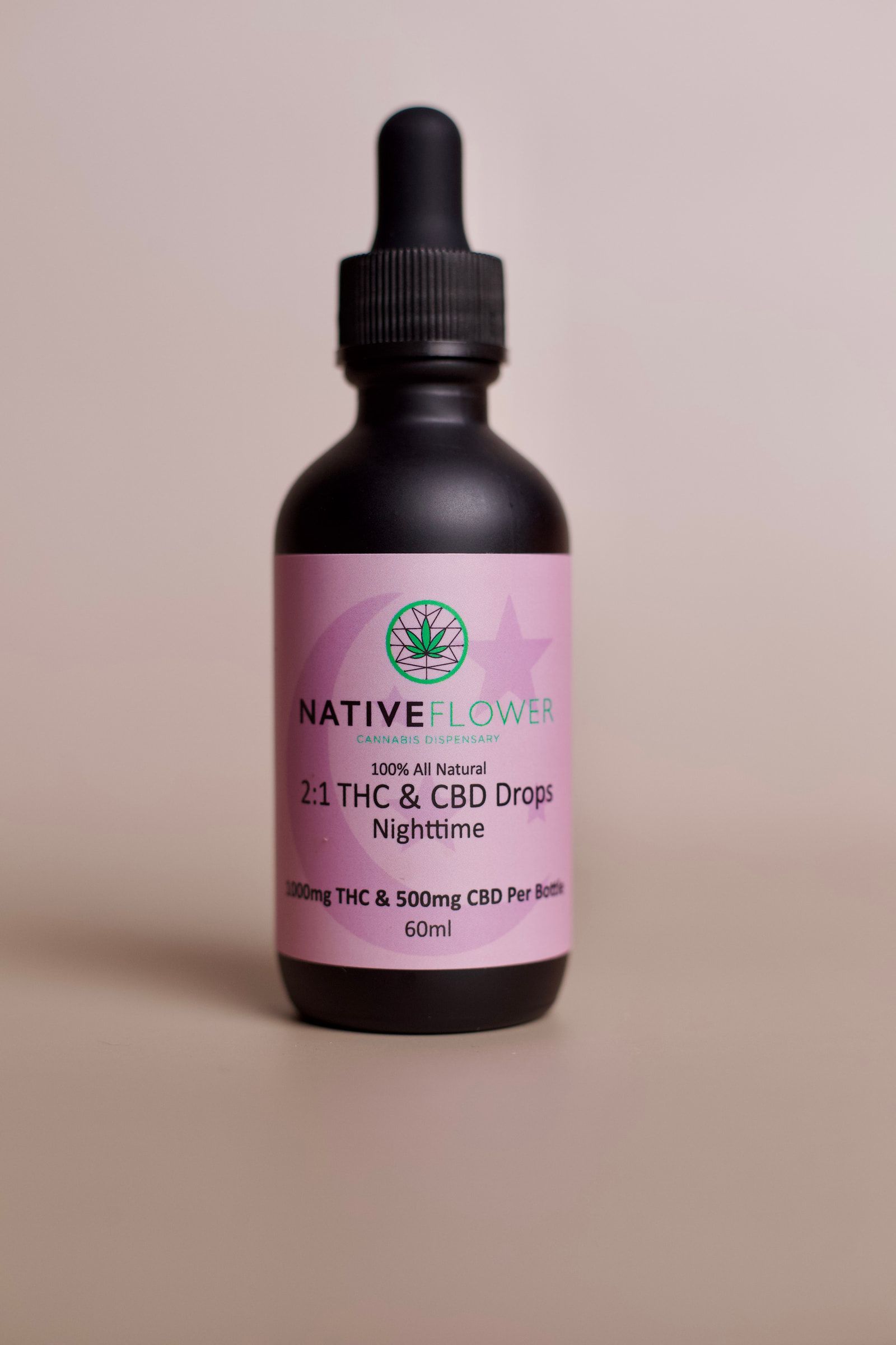 A pink-labelled nighttime bottle with a printed moon and star.
