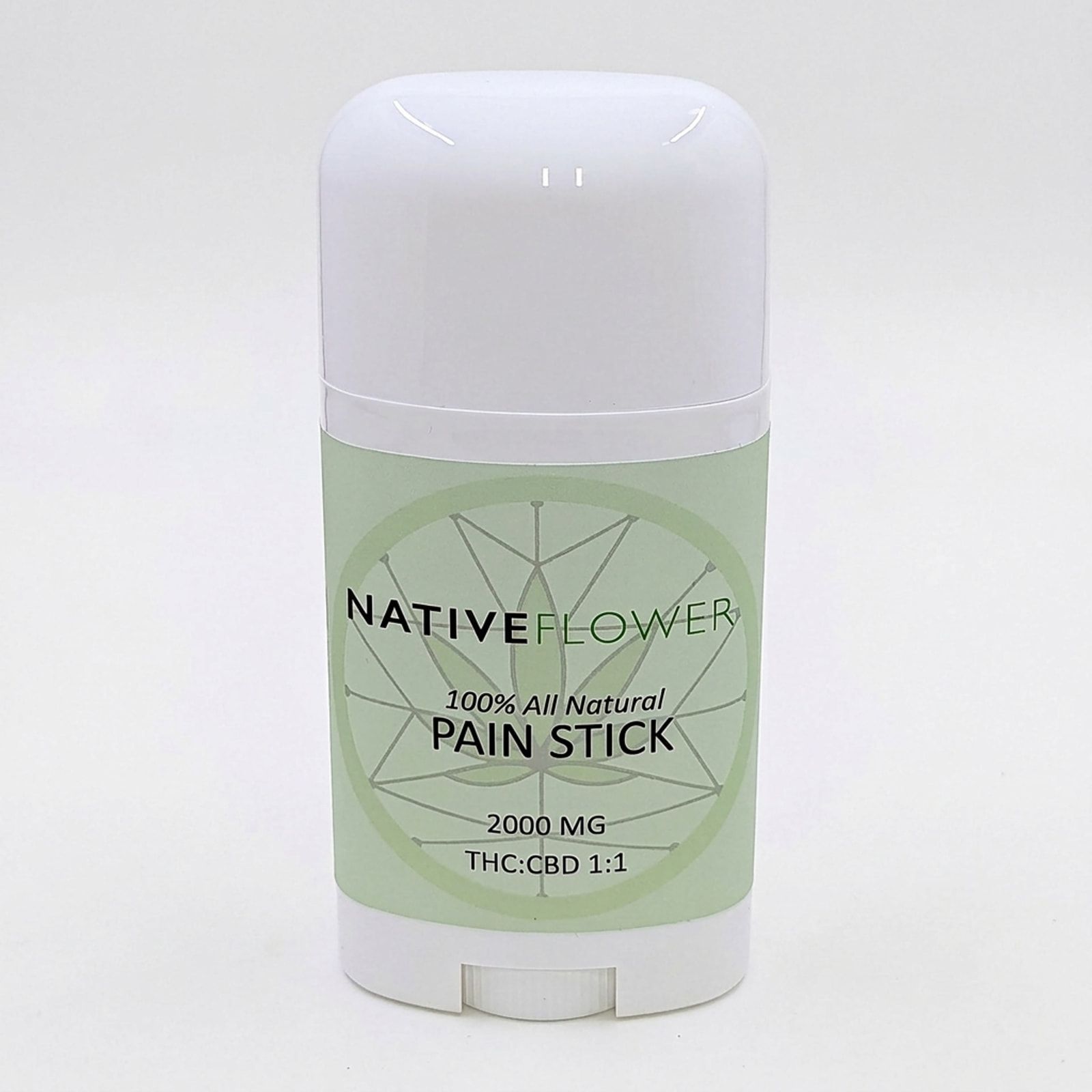 The Native Flower pain stick, a white twist-up tube with a pale green label, standing on a white background.