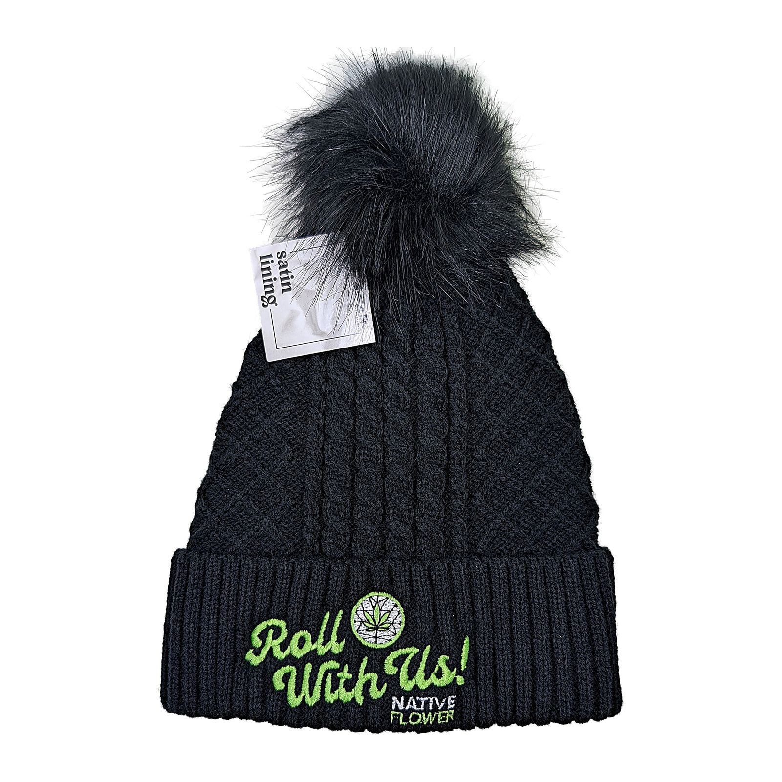 A black cable-knit Native Flower toque with a dark faux-fur pom pom and Roll With Us embroidered on the cuff.