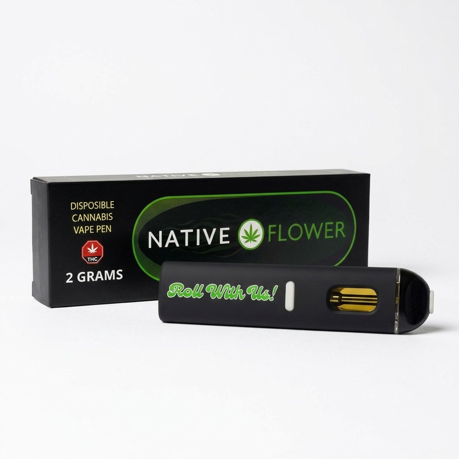A black Native Flower disposable vape pen lying in front of its box on a white background, Roll With Us printed in green on it.