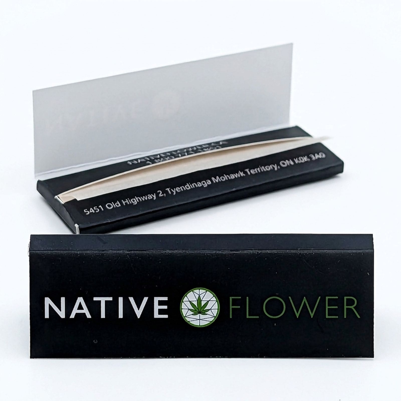 Two black Native Flower rolling paper booklets on a white background, one closed in front and one open behind it showing the papers.