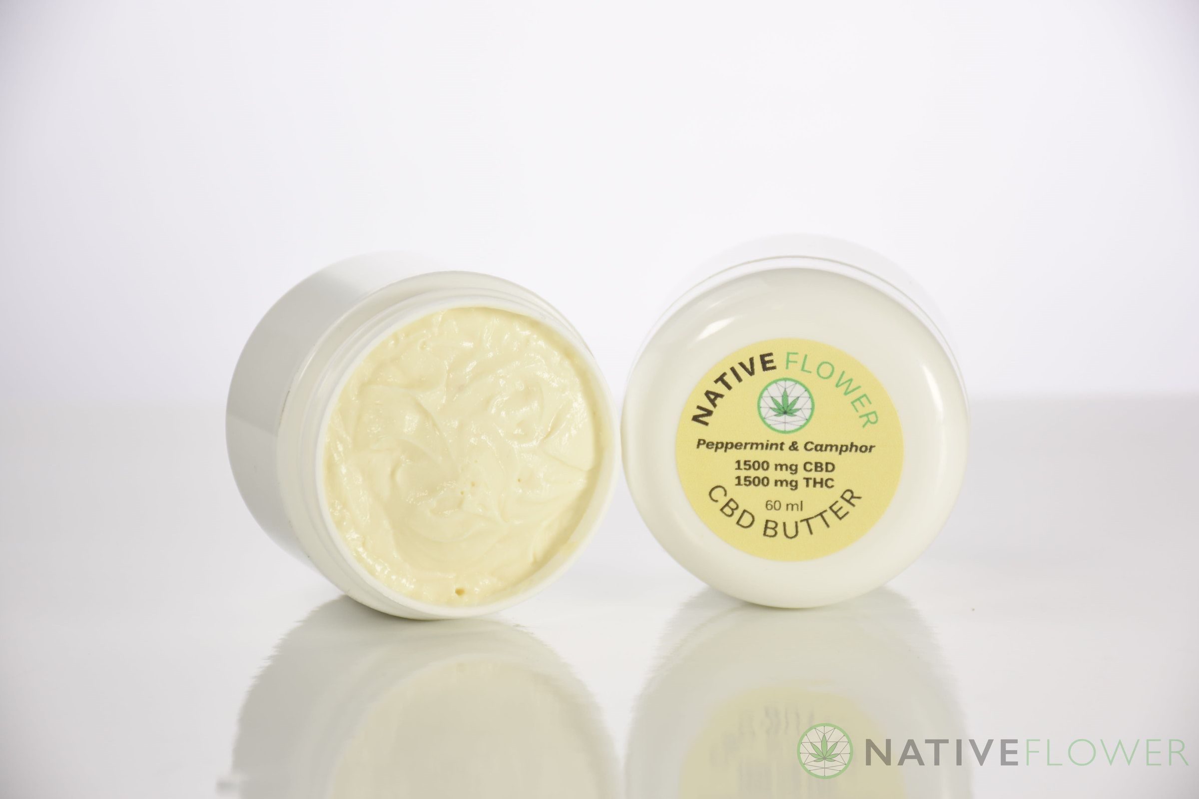 Two tubs of Native Flower butter, one open showing the whipped contents and one showing its label.
