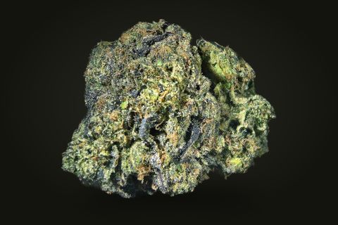 A cured bud of Pinball Wizard, dark green and grey-purple with lime tips and orange hairs, on a plain black background.