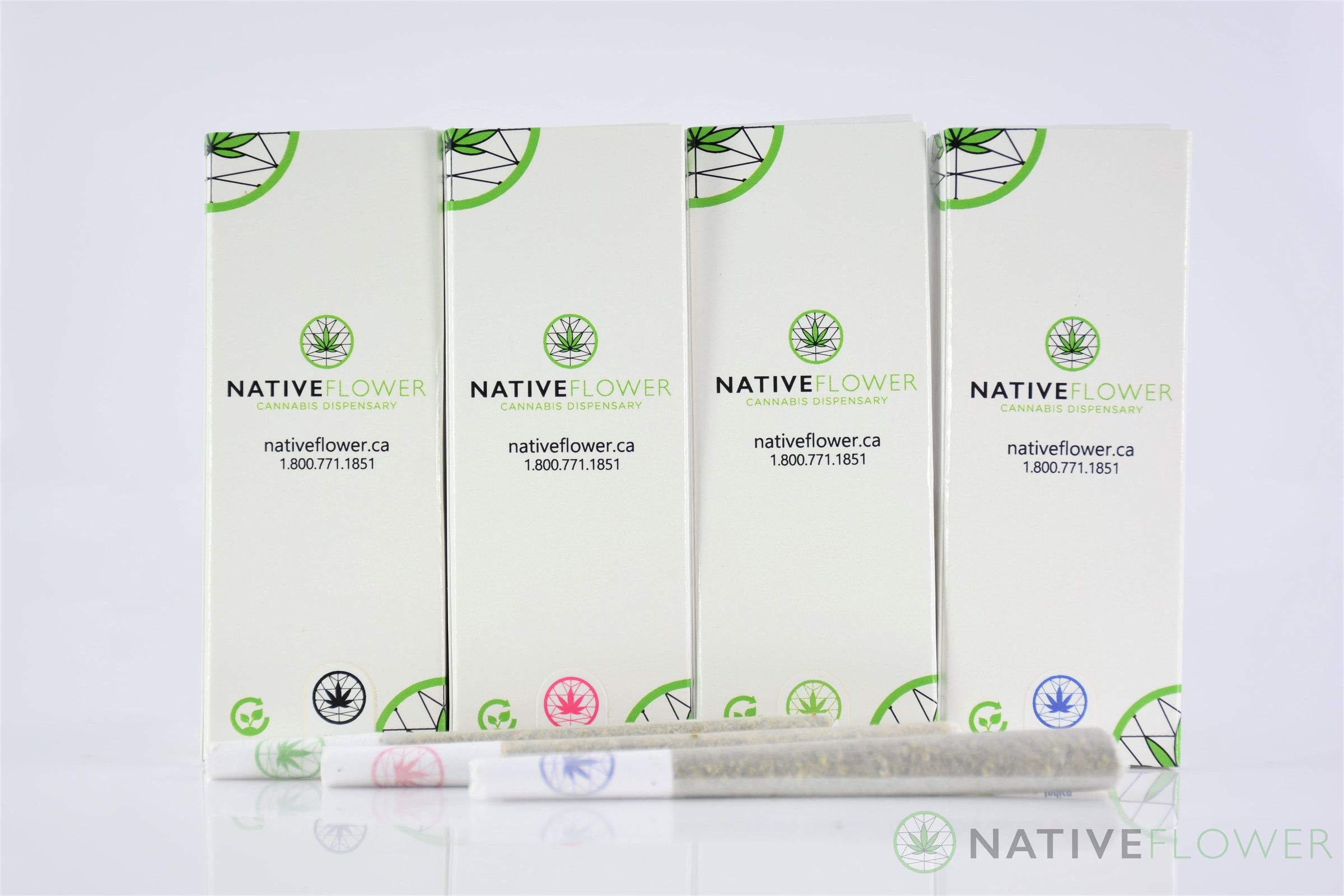 Four white pre-roll boxes in a row with three stamped pre-rolls in front.
