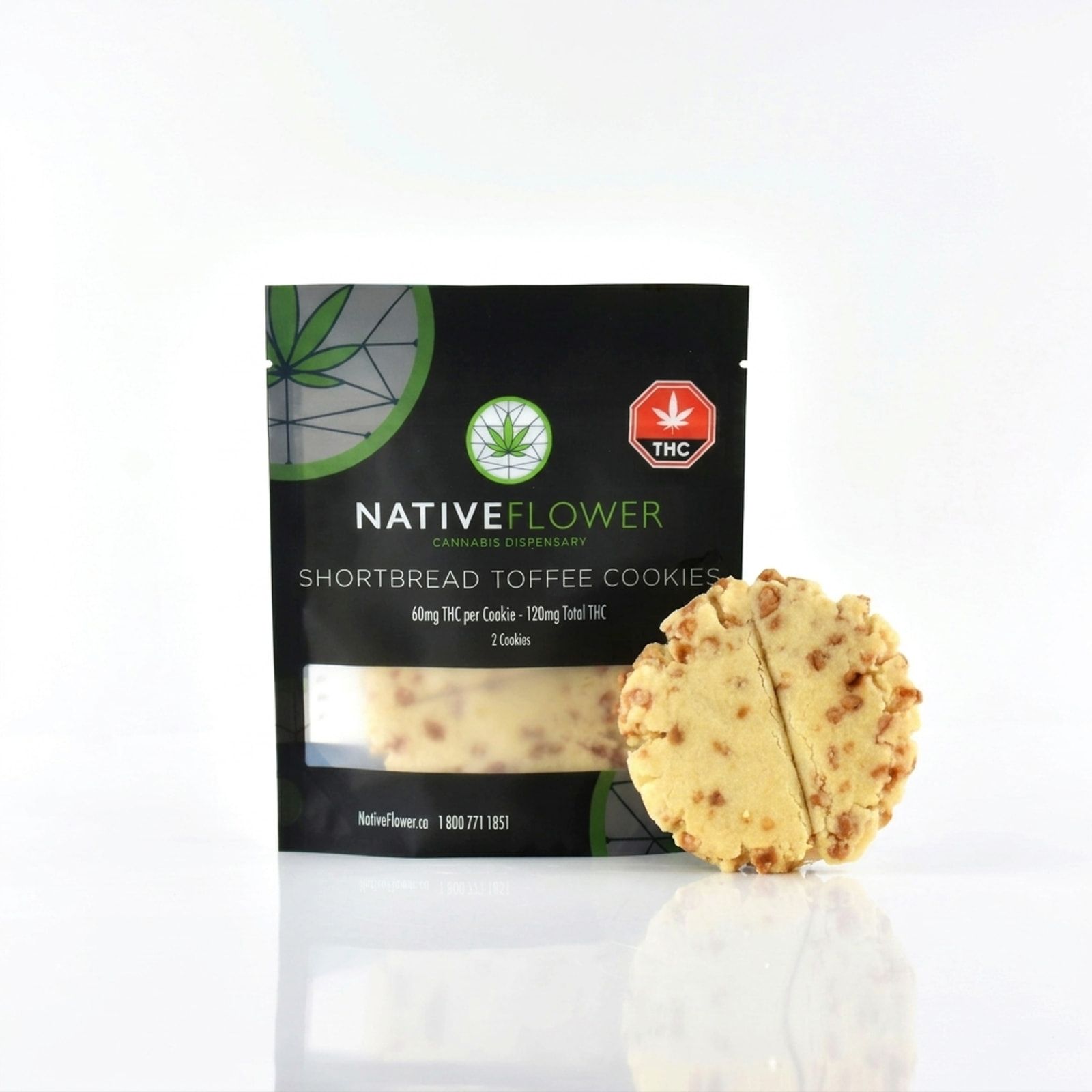 A shortbread toffee cookie, scored in half, leaning against its black Native Flower pouch on a white background.